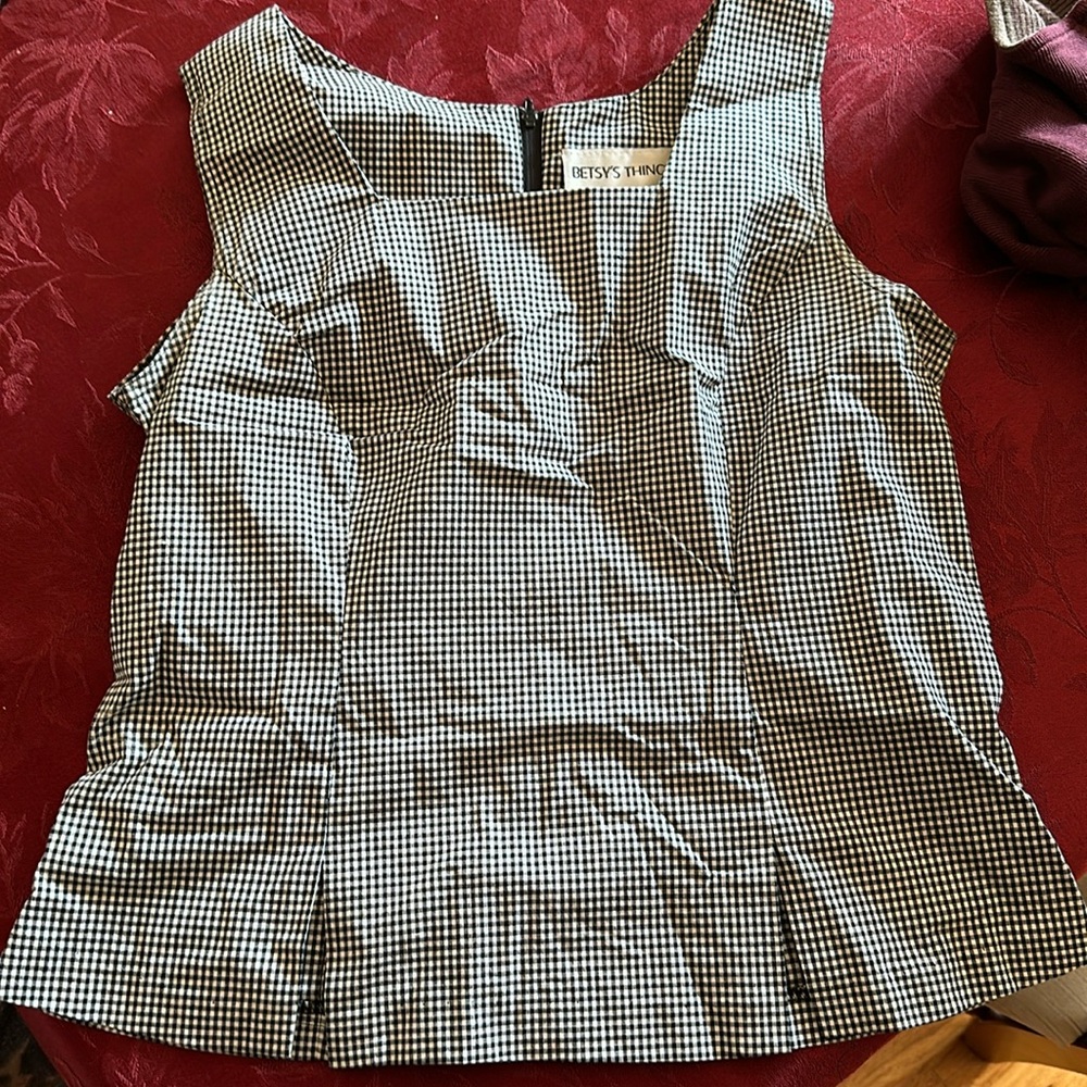 Cute top with zipper on back fitted and then flare at bottom